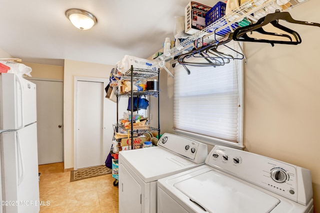 clothes washing area with light tile patterned floors, laundry area, and separate washer and dryer