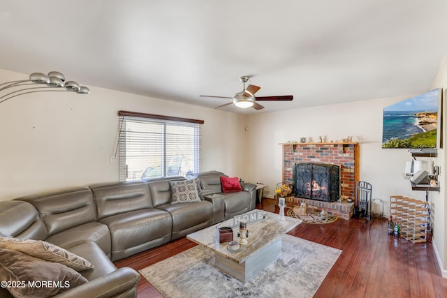 living room featuring a ceiling fan, hardwood / wood-style flooring, and a fireplace