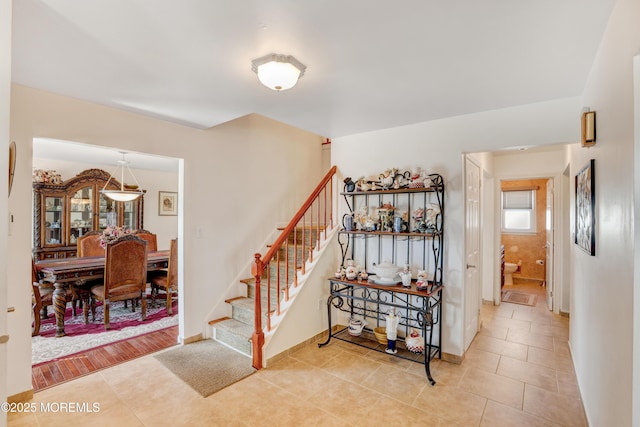 stairs featuring tile patterned floors and baseboards