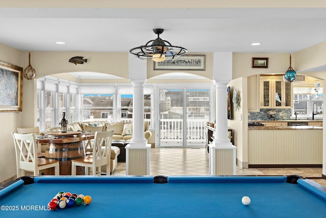 rec room with a healthy amount of sunlight, light tile patterned floors, decorative columns, and pool table