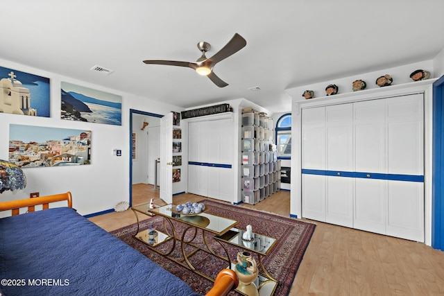 bedroom with a ceiling fan, light wood-type flooring, and visible vents