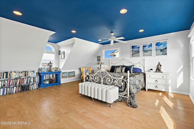 bedroom with baseboards, vaulted ceiling, wood finished floors, and recessed lighting