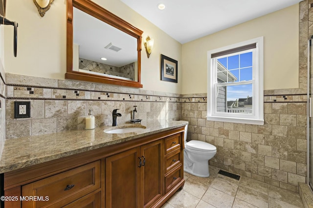 bathroom with toilet, tile patterned flooring, vanity, and visible vents