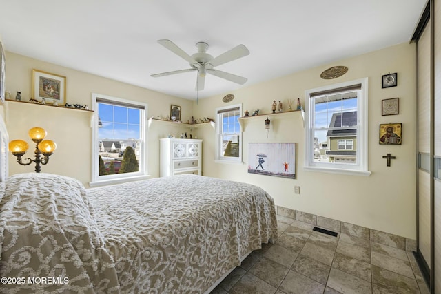 bedroom featuring visible vents and ceiling fan