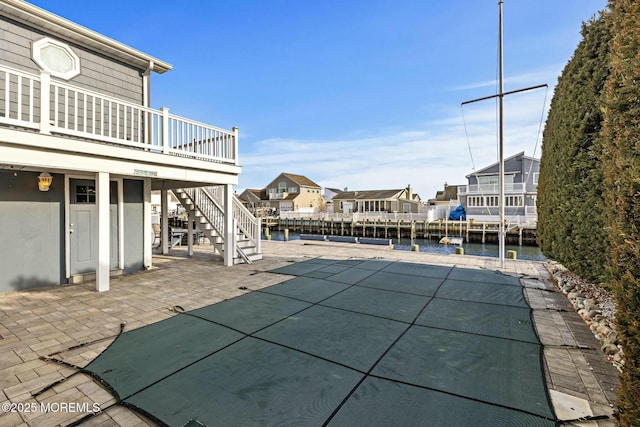 view of swimming pool featuring a residential view, a deck with water view, a patio, and stairway