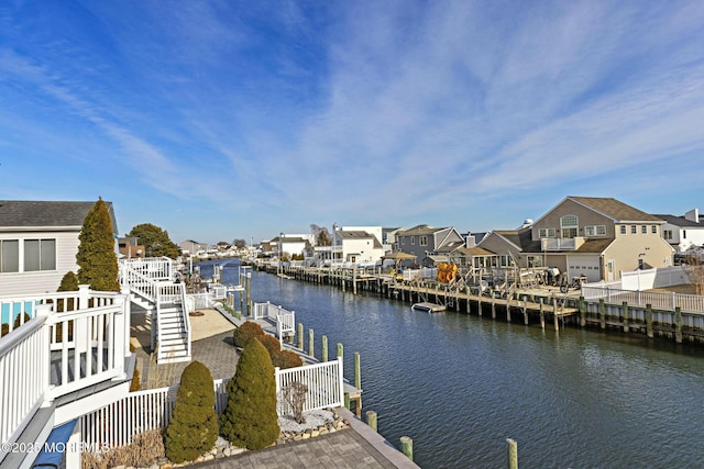 dock area featuring a residential view, a water view, and fence