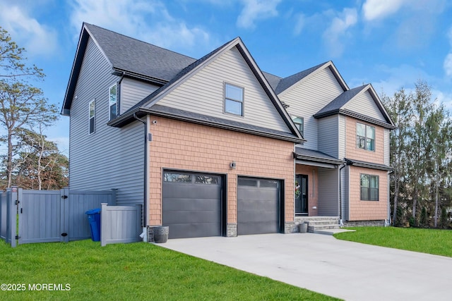 traditional-style home featuring a garage, fence, concrete driveway, a gate, and a front lawn