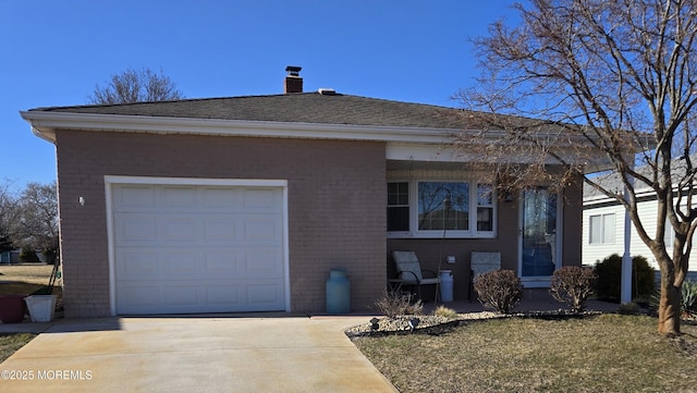 view of front of home featuring brick siding, a shingled roof, concrete driveway, a chimney, and an attached garage