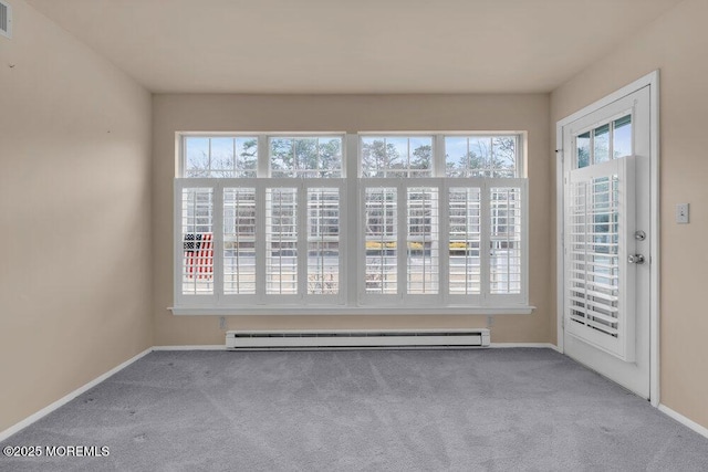 unfurnished room with plenty of natural light, a baseboard radiator, and carpet