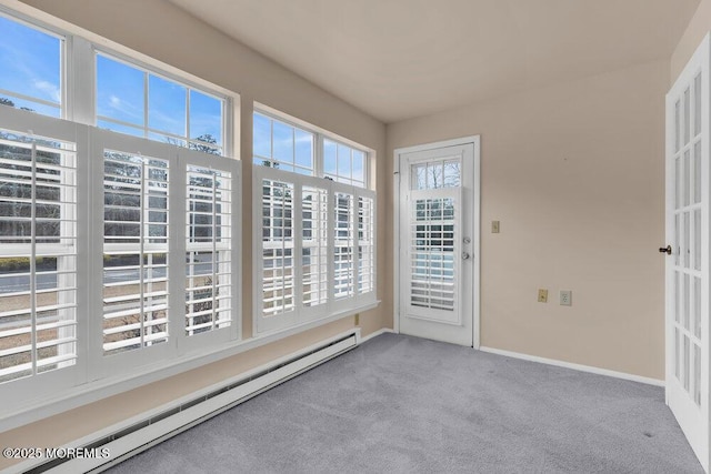 unfurnished sunroom featuring a baseboard heating unit