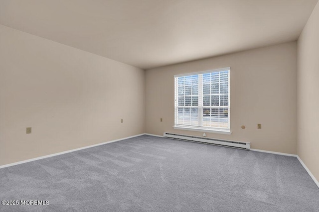 carpeted spare room featuring baseboards and a baseboard heating unit