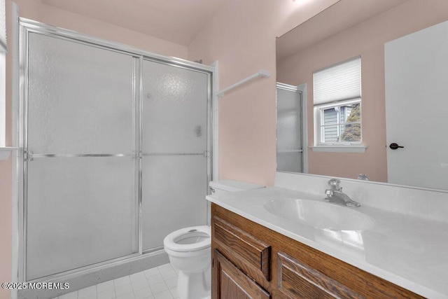 full bathroom featuring vanity, tile patterned flooring, a shower stall, and toilet