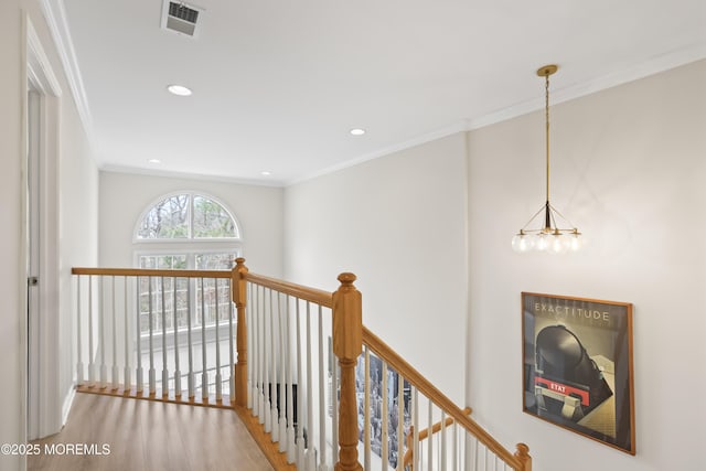 corridor featuring an upstairs landing, recessed lighting, visible vents, and ornamental molding