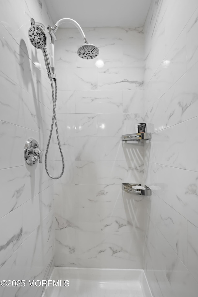 full bath featuring a tile shower