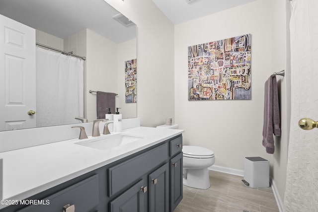 bathroom with baseboards, visible vents, a shower with shower curtain, toilet, and vanity