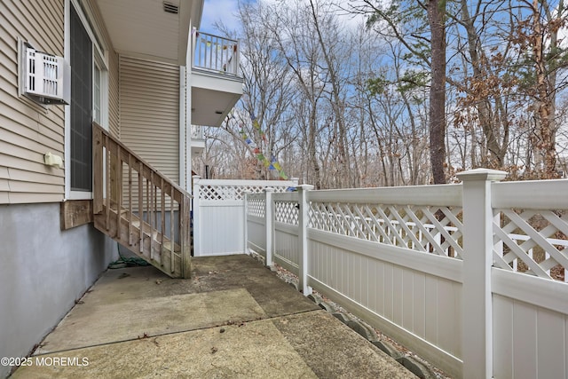 view of patio / terrace featuring fence and a balcony