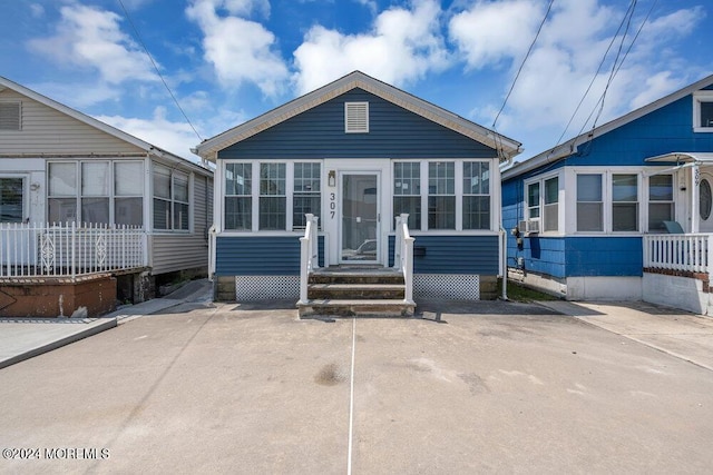 view of front of house with a sunroom