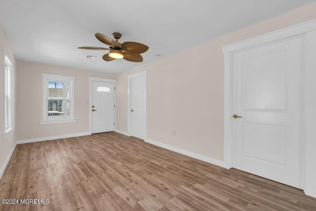 entrance foyer with light wood-style floors, visible vents, baseboards, and a ceiling fan