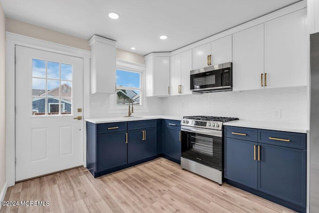 kitchen with light countertops, appliances with stainless steel finishes, and blue cabinets