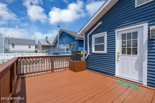 wooden terrace with a residential view and cooling unit