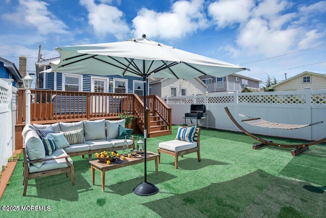 exterior space featuring a deck, a fenced backyard, and an outdoor living space