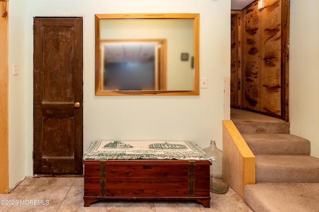 hall with stairway and tile patterned flooring