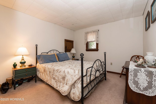 bedroom featuring baseboards and carpet flooring