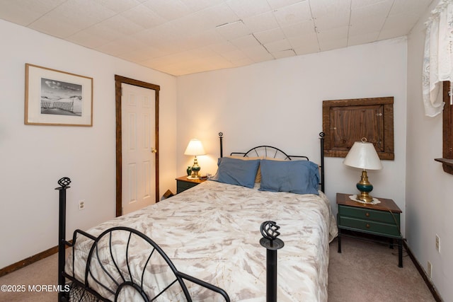 carpeted bedroom featuring baseboards