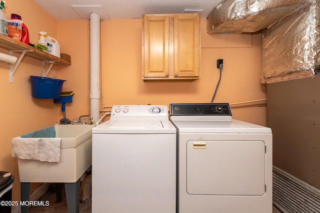 laundry room featuring a sink, cabinet space, and washer and dryer