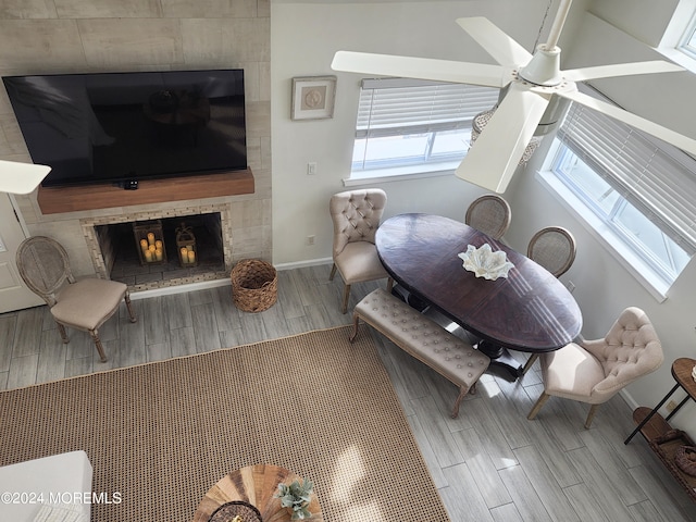 living room with a fireplace, baseboards, and wood finish floors