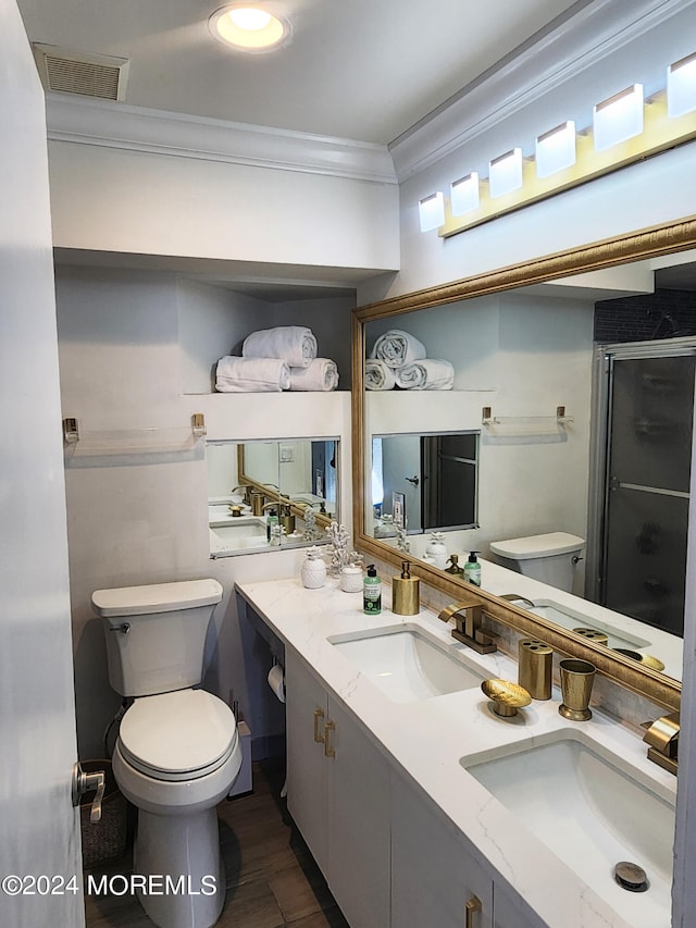 bathroom with ornamental molding, visible vents, a sink, and toilet