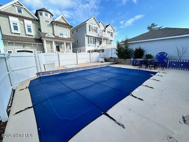 view of pool with a patio, a residential view, fence, and a fenced in pool