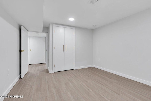 unfurnished bedroom with baseboards, visible vents, and light wood finished floors