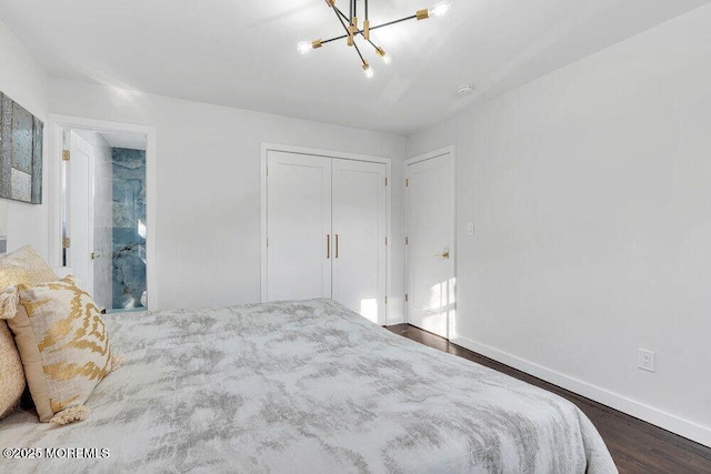 bedroom featuring a chandelier, a closet, dark wood finished floors, and baseboards