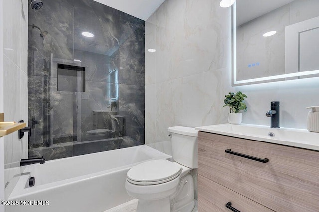 bathroom with toilet, tile walls, and vanity