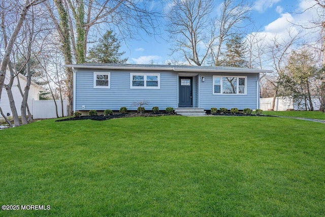 view of front of house featuring a front yard and fence