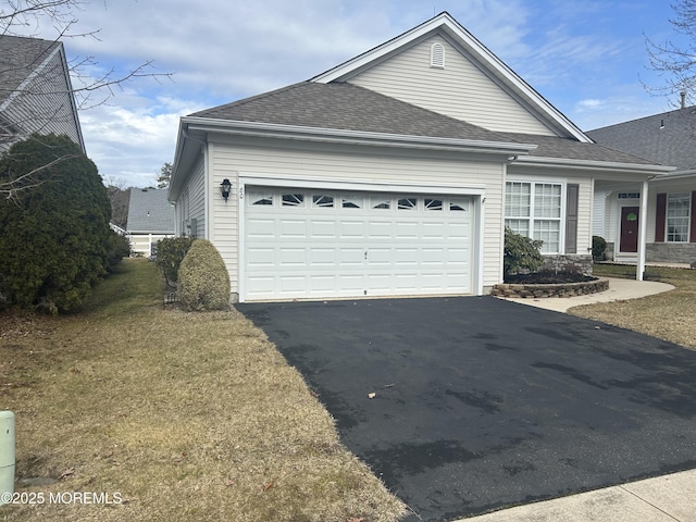 view of property exterior with driveway, a shingled roof, and an attached garage