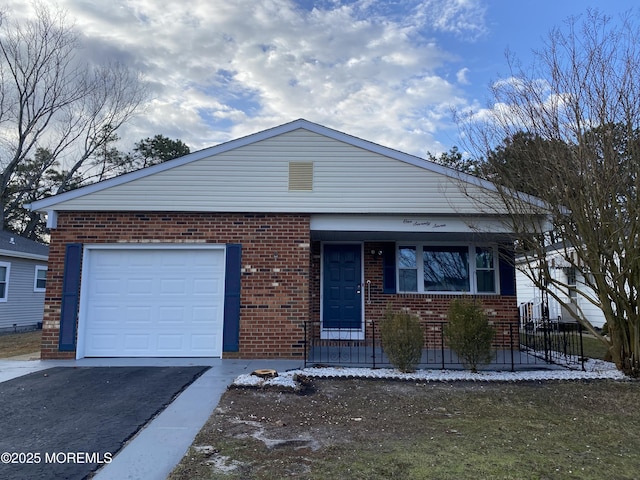 view of front of house with a porch, brick siding, an attached garage, and driveway