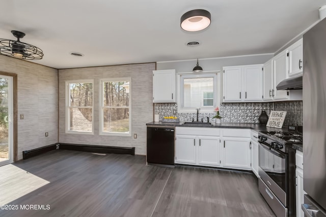 kitchen featuring gas stove, visible vents, under cabinet range hood, dishwasher, and dark countertops