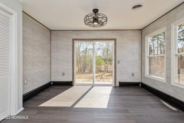 unfurnished sunroom featuring visible vents and plenty of natural light