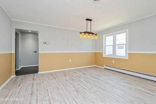 empty room with baseboards, baseboard heating, wood finished floors, and ornamental molding