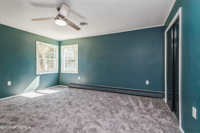 empty room with visible vents, a ceiling fan, carpet, and a baseboard radiator