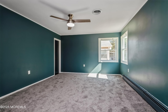 carpeted spare room featuring a baseboard heating unit, visible vents, baseboards, and ceiling fan