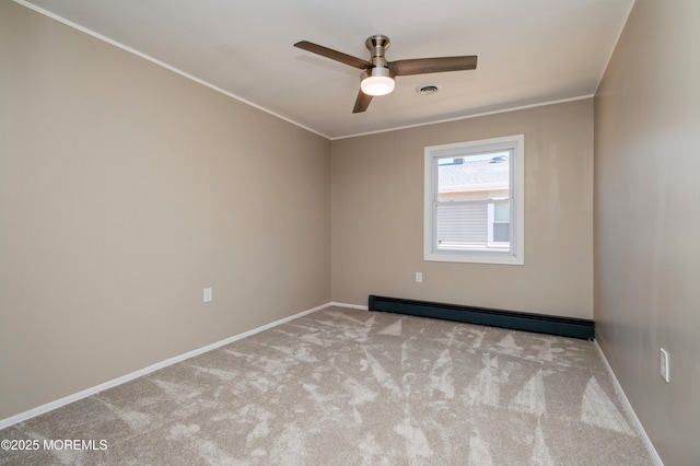 carpeted empty room featuring visible vents, a baseboard heating unit, baseboards, ornamental molding, and a ceiling fan