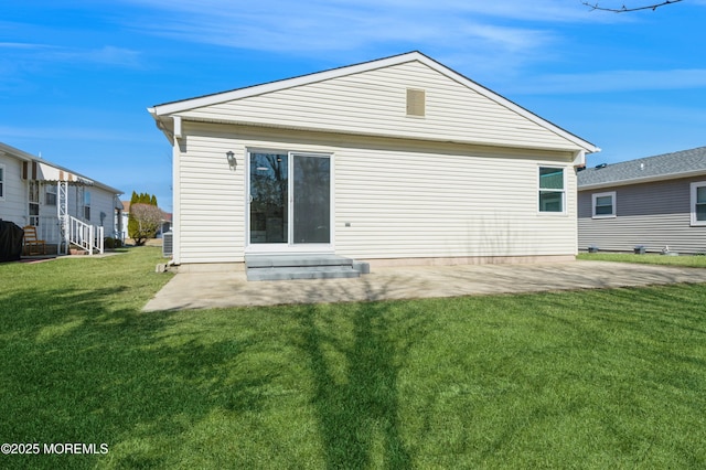 rear view of house with a patio area, entry steps, and a yard