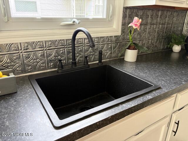 177 Freeport Blvd, Toms River, NJ 08757 - kitchen view of a sink, backsplash, and dark countertops
