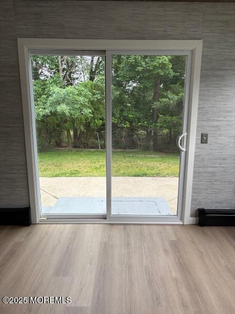177 Freeport Blvd, Toms River, NJ 08757 - doorway to outside with wood finished floors and a baseboard heating unit