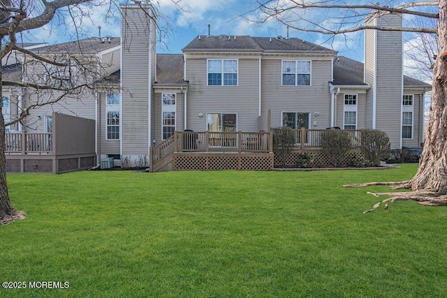 rear view of house with a wooden deck, central AC unit, a lawn, and a chimney