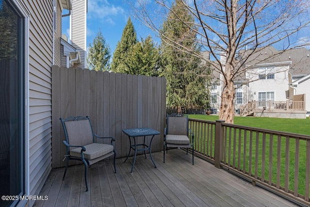 wooden deck featuring a yard