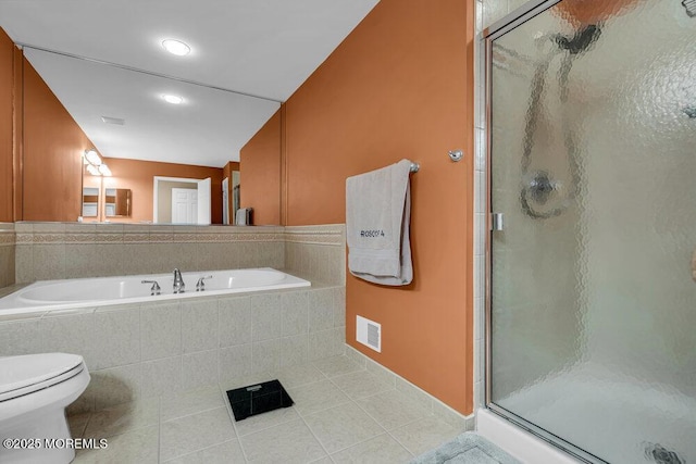 bathroom featuring tile patterned flooring, a bath, visible vents, and a stall shower